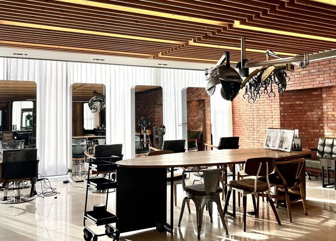 Modern interior of 준오헤어 명동4호점 Juno Hair Myungdong 4, Seoul, featuring stylish seating in a sunlit space.