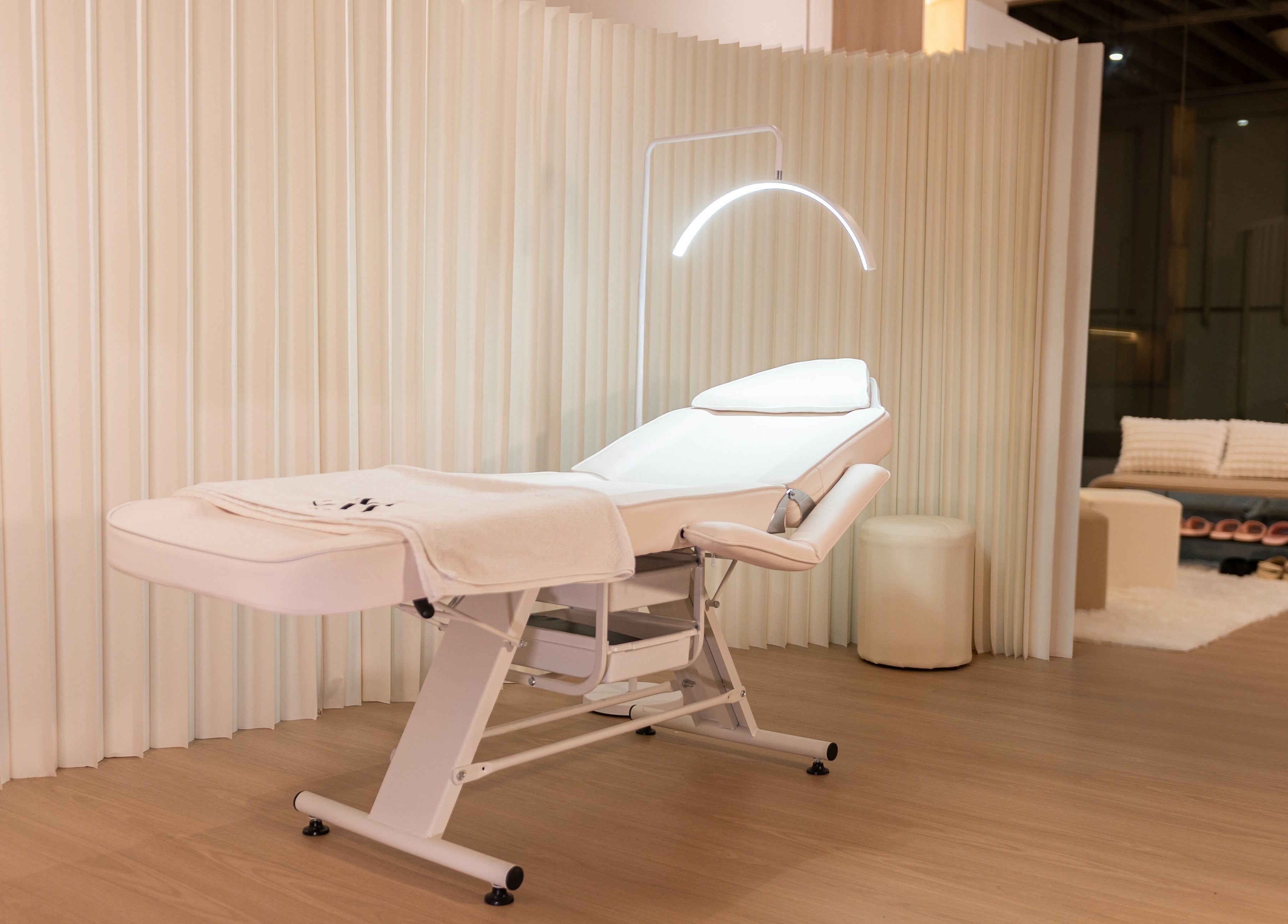 Luxurious treatment room at AURA Hexacube Studio, Singapore, SG with a modern white therapy bed.