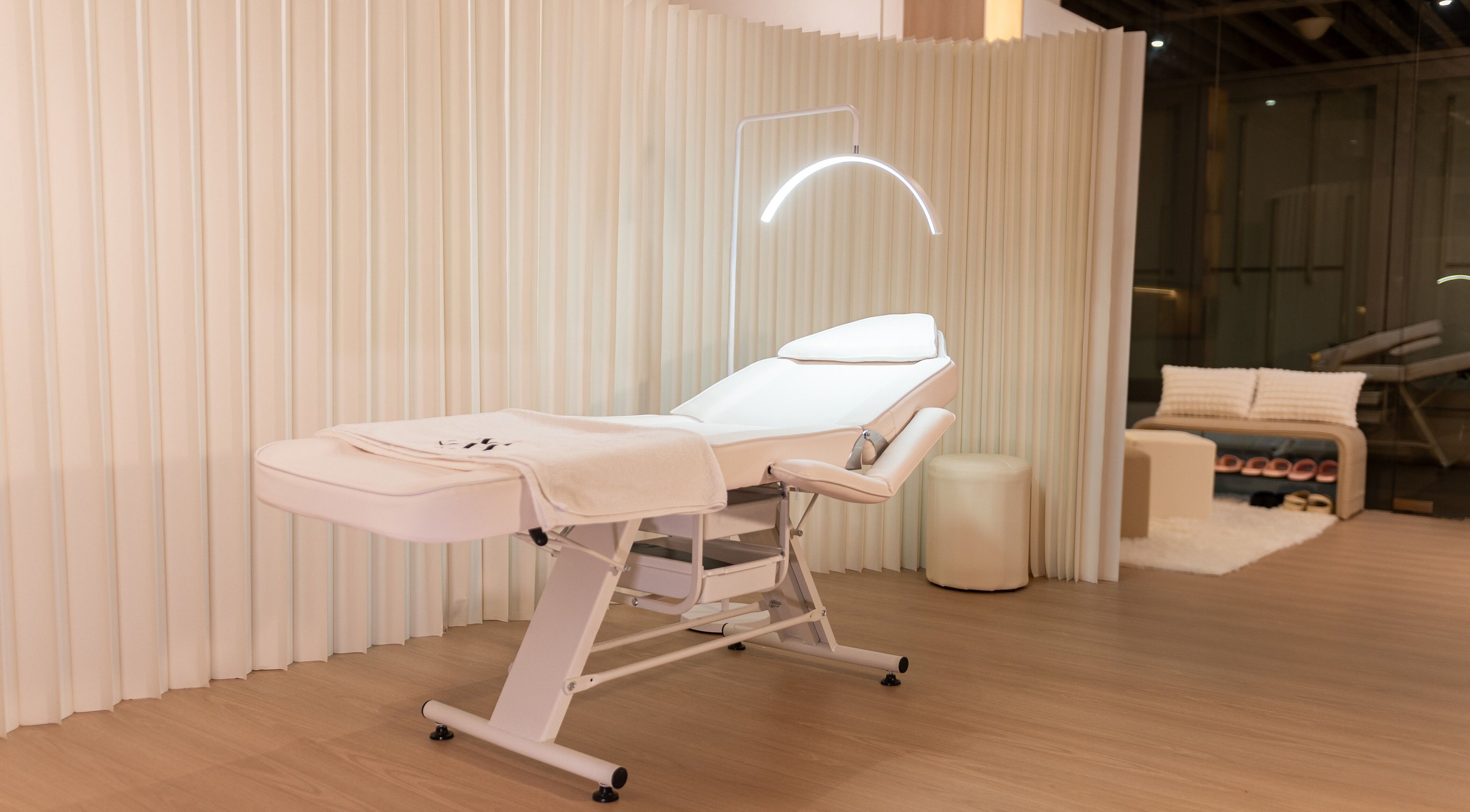 Luxurious treatment room at AURA Hexacube Studio, Singapore, SG with a modern white therapy bed.