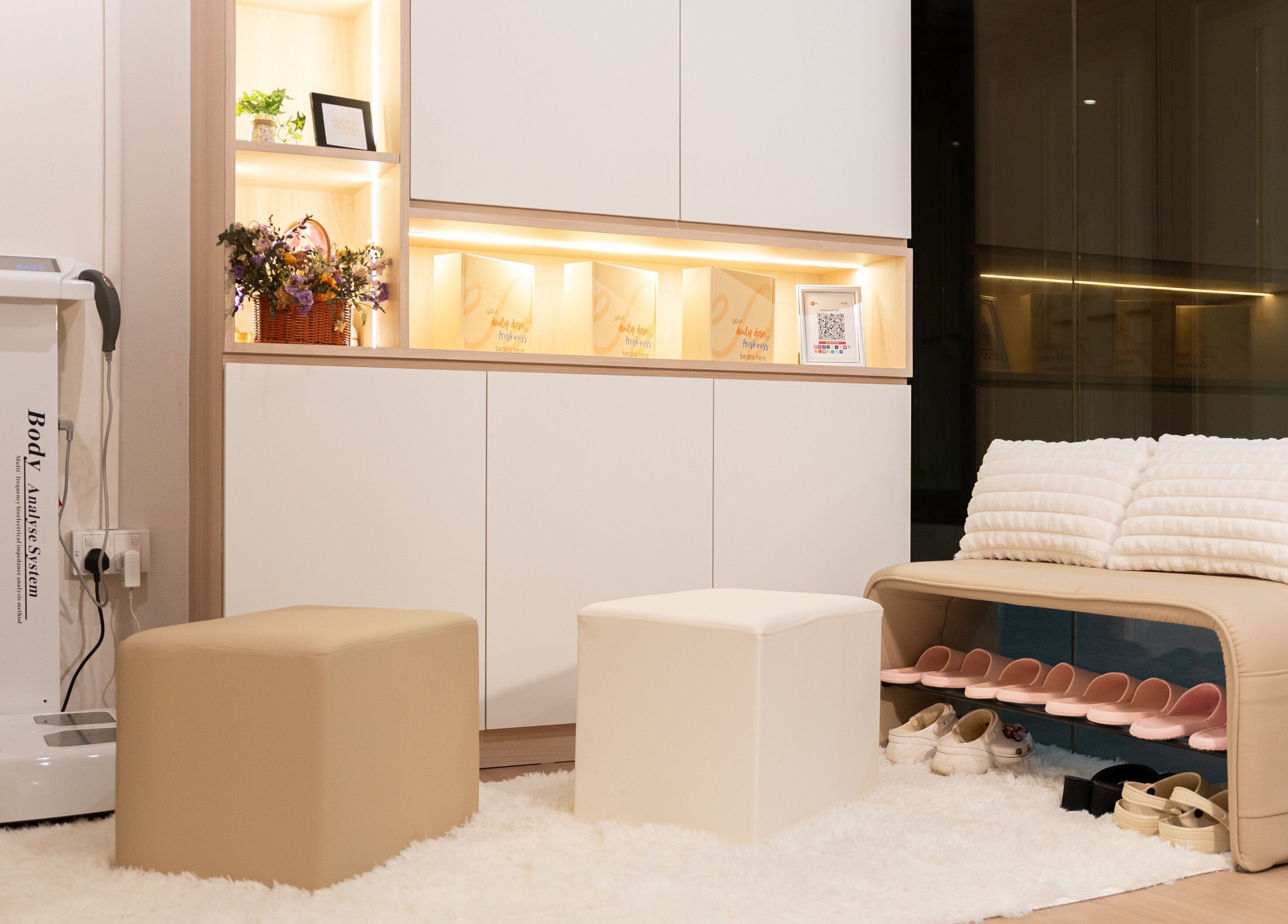 Welcoming reception area at AURA Hexacube Studio, Singapore, SG, with plush seating and warm lighting.