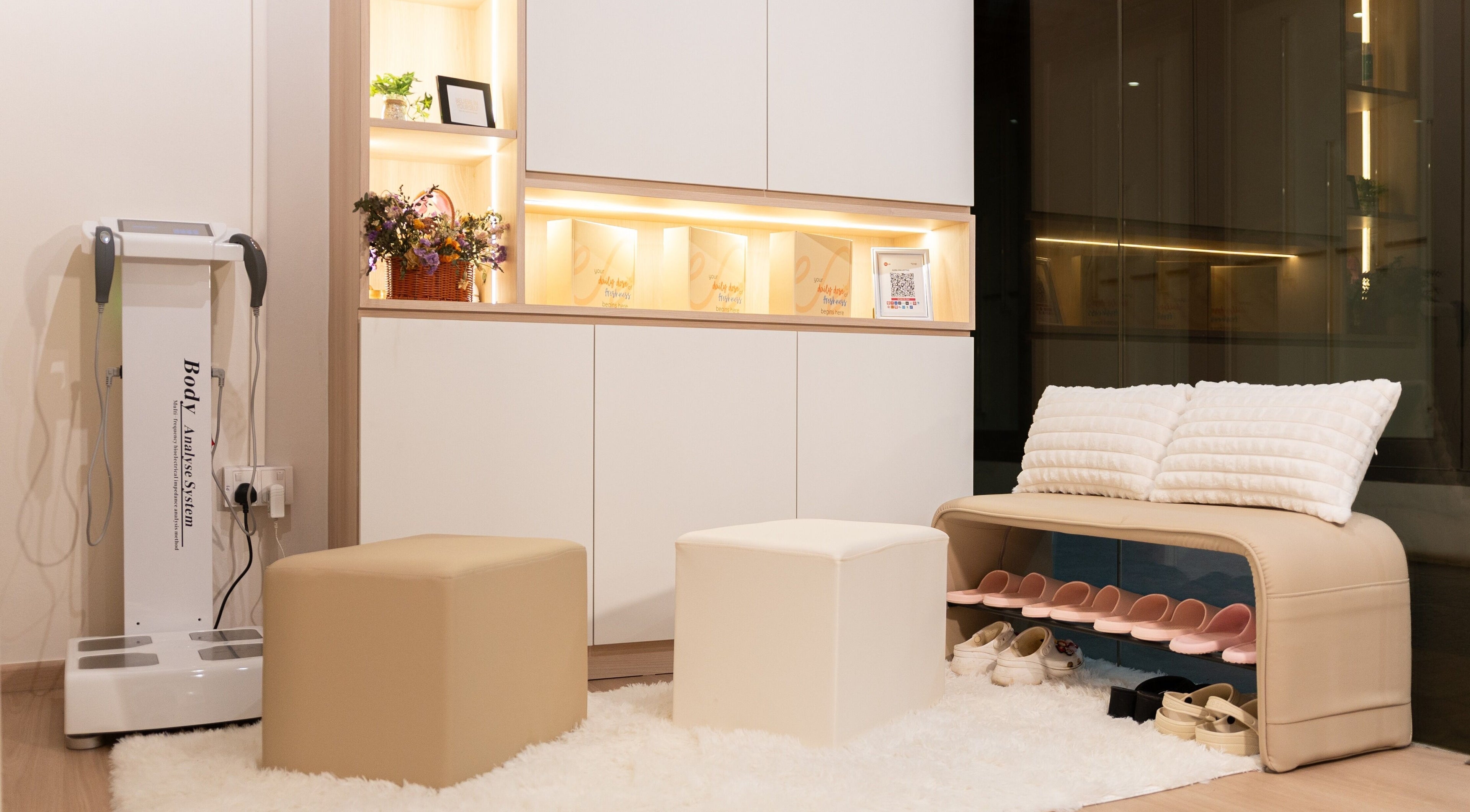 Welcoming reception area at AURA Hexacube Studio, Singapore, SG, with plush seating and warm lighting.