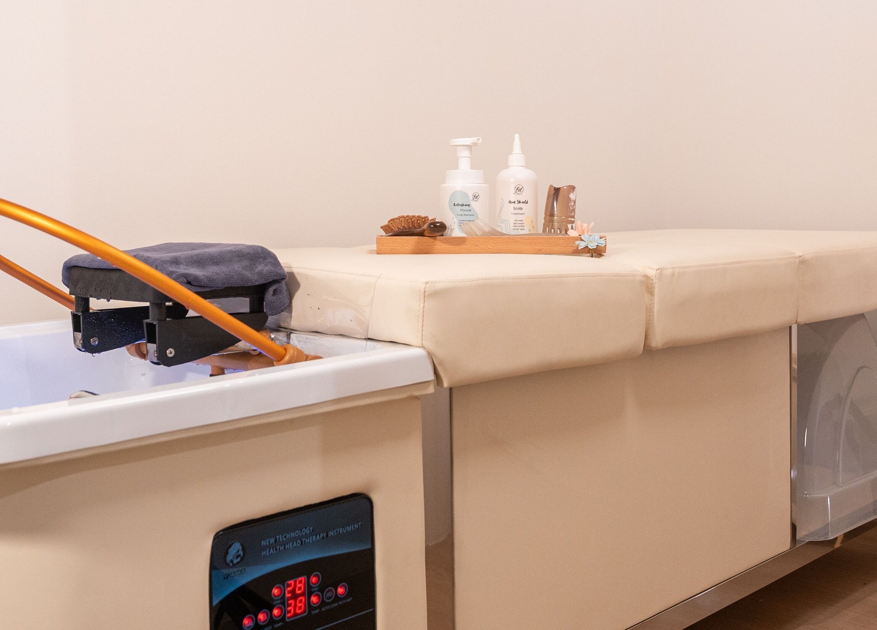 Relaxing spa bed setup at AURA Hexacube Studio in Singapore, SG, featuring plush amenities for a soothing experience.