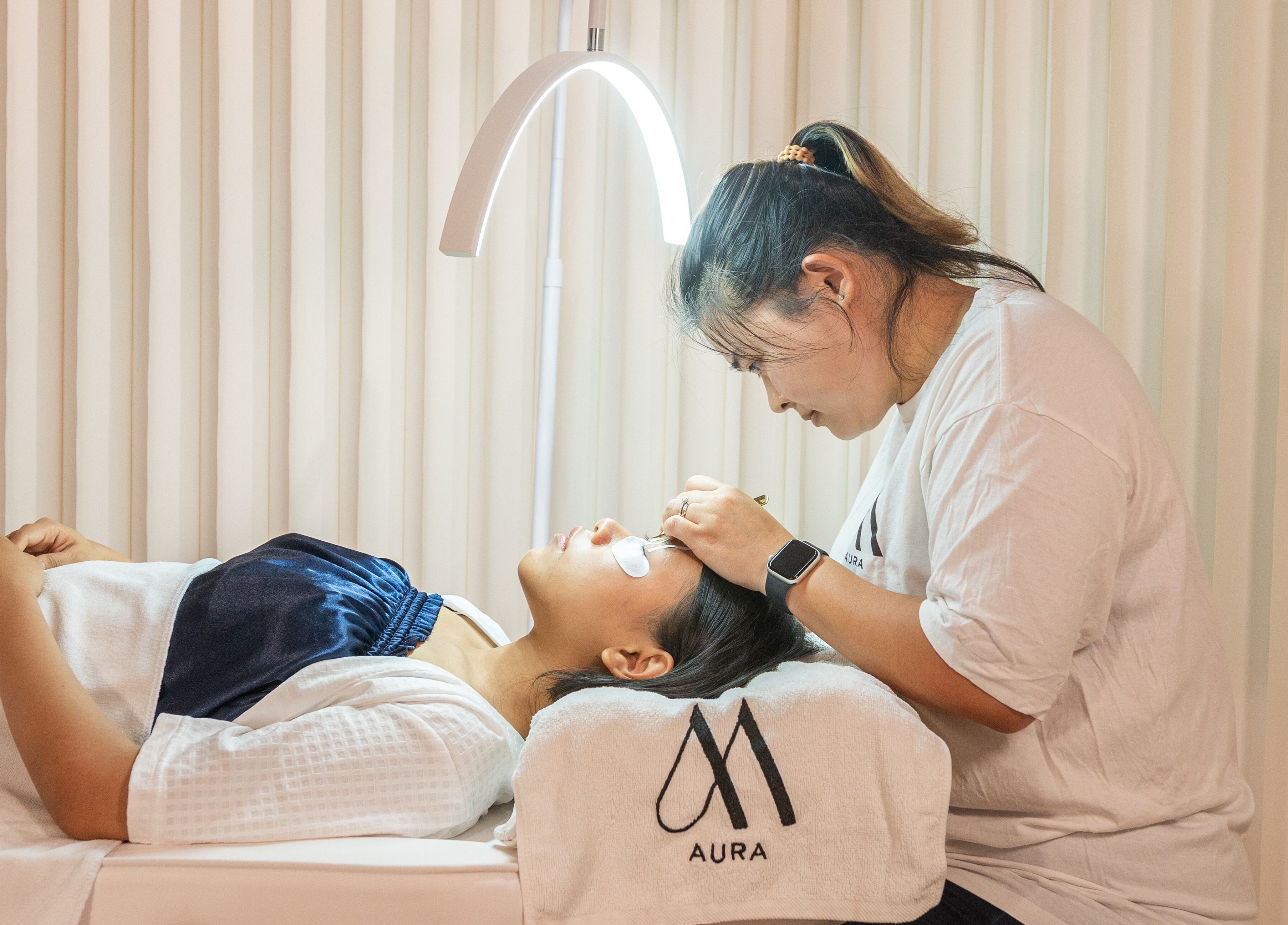 A beautician performs a lash extension at AURA Hexacube Studio, Singapore, Singapore, SG.