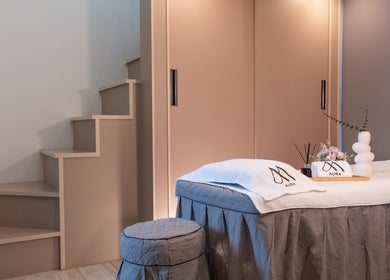 Luxurious massage table setup at AURA J Gateway Studio, Singapore, SG, exuding calm elegance.