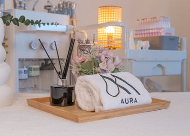Serene setting at AURA J Gateway Studio in Singapore, featuring elegant decor and spa essentials.