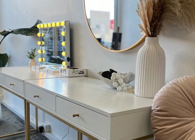 Sophisticated salon vanity at DDIOR | HAIR Richmond, Victoria, AU featuring chic decor and illuminated mirror.