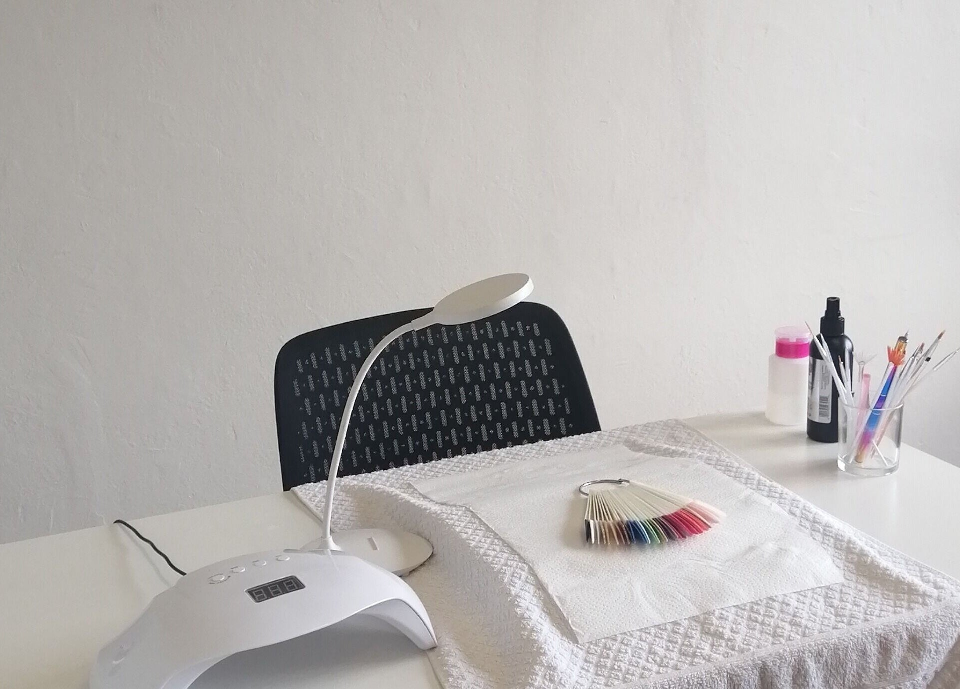 Manicure station at Luminous Nails, Outer West Durban, Kwazulu-natal, ZA with tools and lamp.