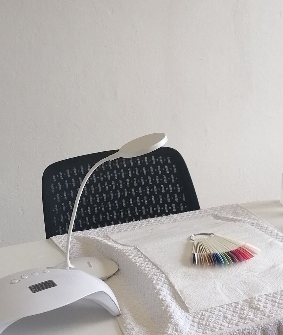 Manicure station at Luminous Nails, Outer West Durban, Kwazulu-natal, ZA with tools and lamp.