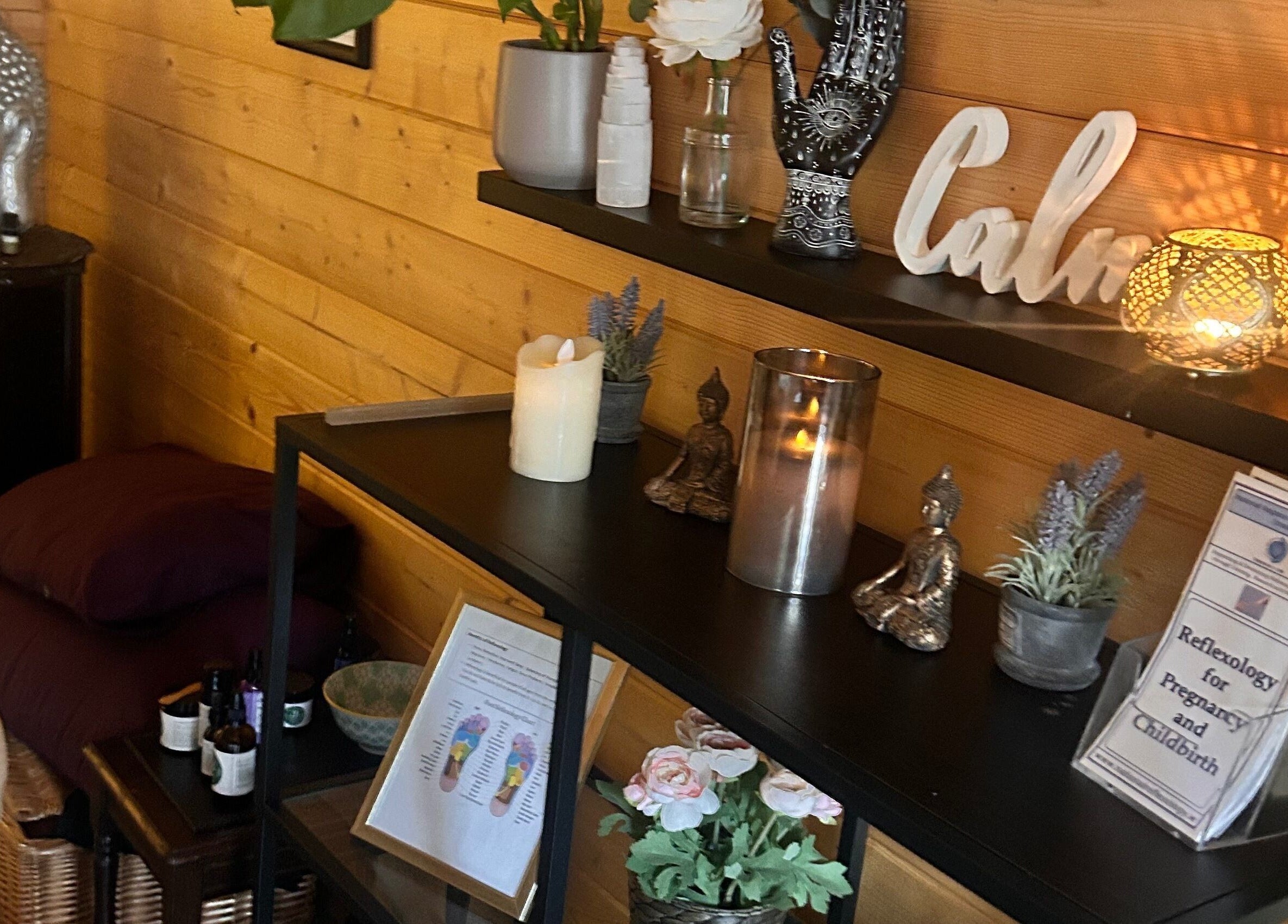 Serene wellness corner at The Relaxation Hub, Dublin, Dublin 4, IE with candles and Buddha statue.