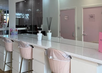 Chic seating arrangement at The Salon Sanctuary, Liverpool, England, GB, with pink and gold accents.