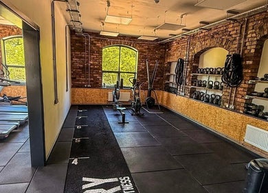 Modern gym area at Naomi Clarke PT-The Quarry Health and Fitness in Backwell, England featuring equipment and natural light.