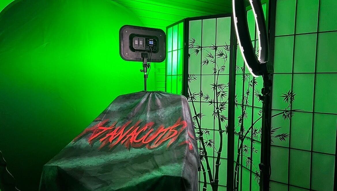 Tanacuts Melbourne, Victoria, AU: Chic salon space with green lighting and bamboo decor for serene beauty experiences.