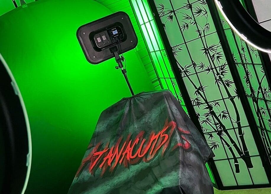 Tanacuts studio in Melbourne, Victoria, AU features glowing green ambiance with bamboo decor.