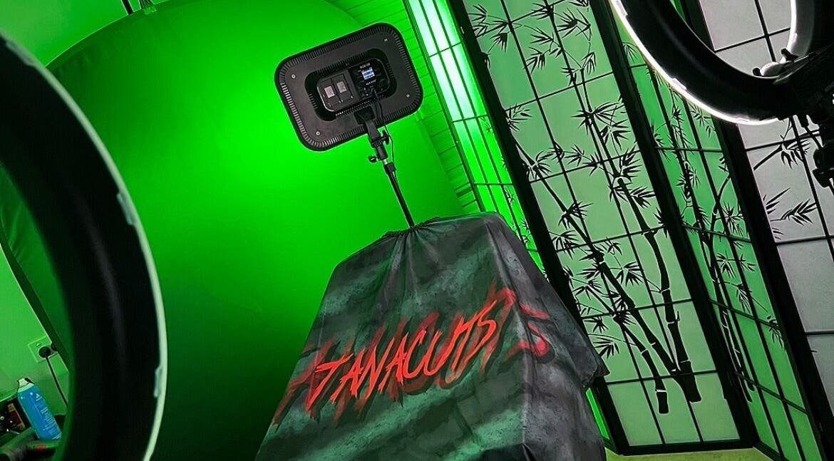 Tanacuts studio in Melbourne, Victoria, AU features glowing green ambiance with bamboo decor.