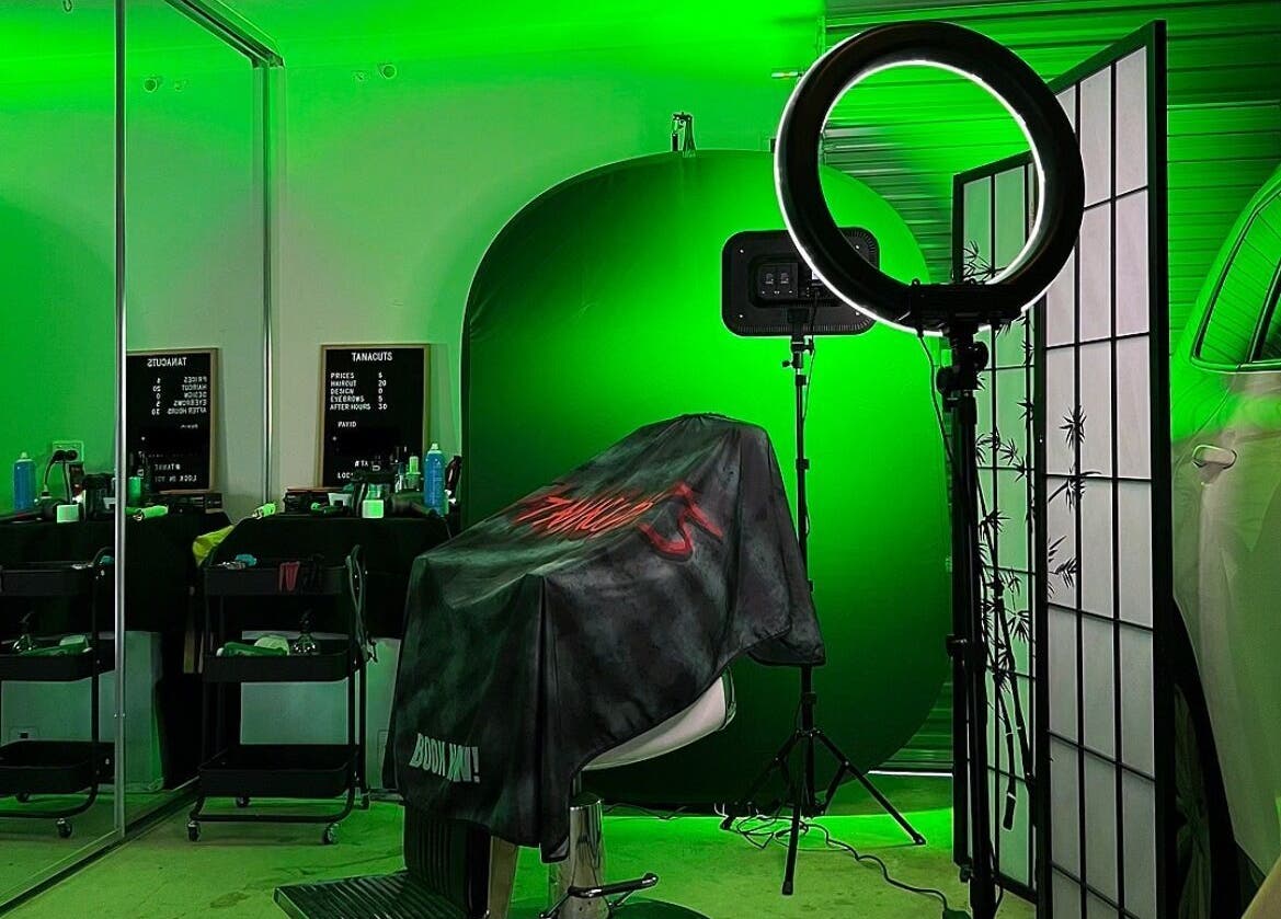 Modern salon setup at Tanacuts, Melbourne, Victoria, AU with vibrant green lighting and stylish decor.