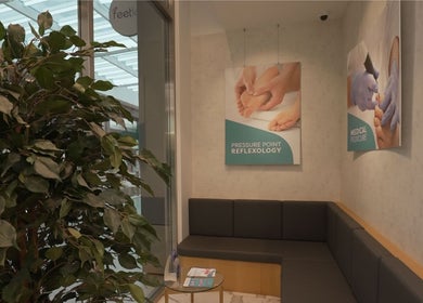 Relaxing seating area at Feetlab Podiatry L.L.C - Dubai Hills Mall, Dubai, AE with reflexology posters.