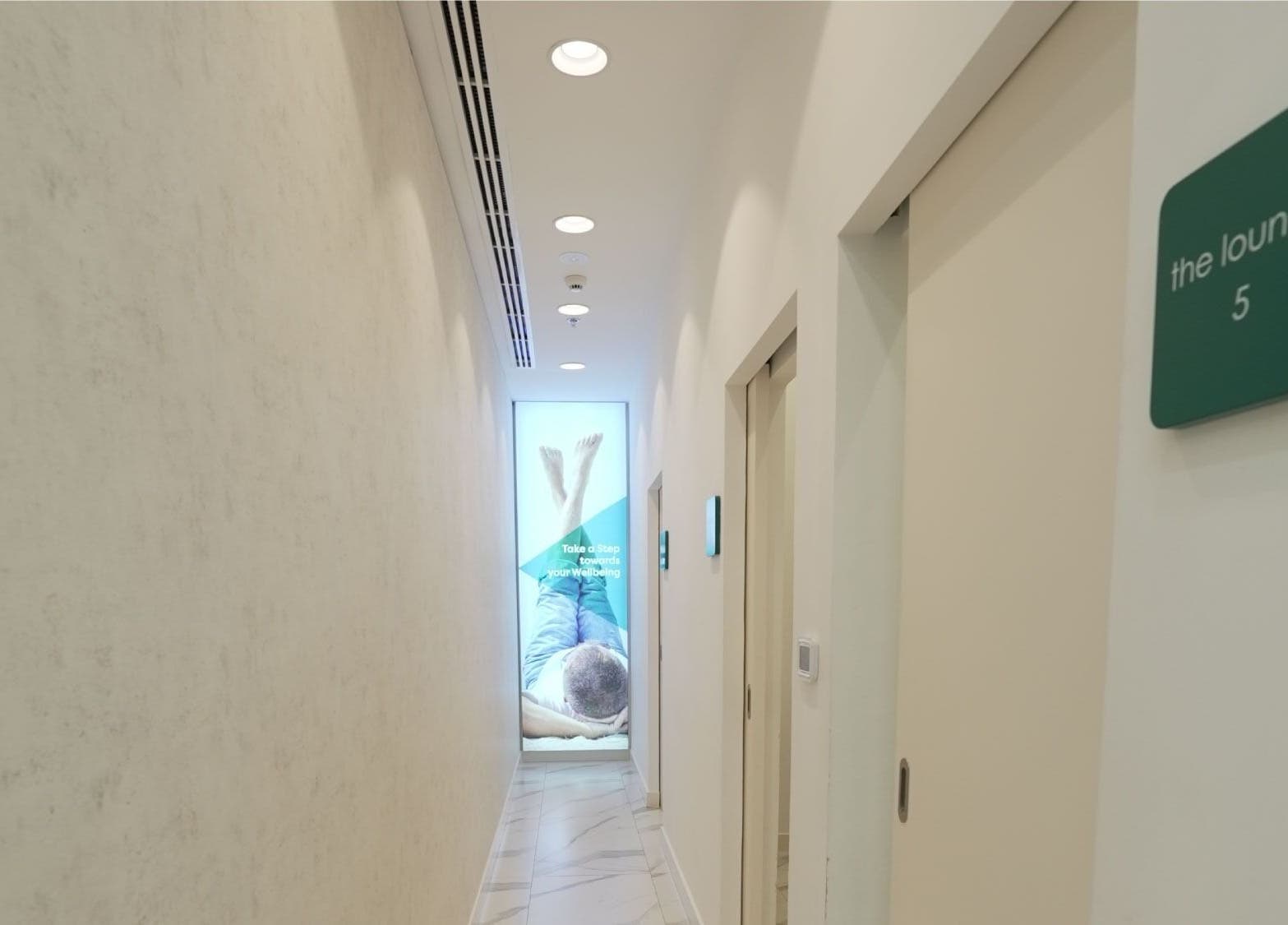 Bright hallway at Feetlab Podiatry L.L.C - Dubai Hills Mall, Dubai, AE, leading to therapy rooms.