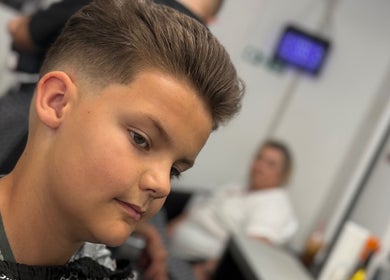 Young boy with stylish fade haircut at Epic Barber Woking, Woking, England, GB.