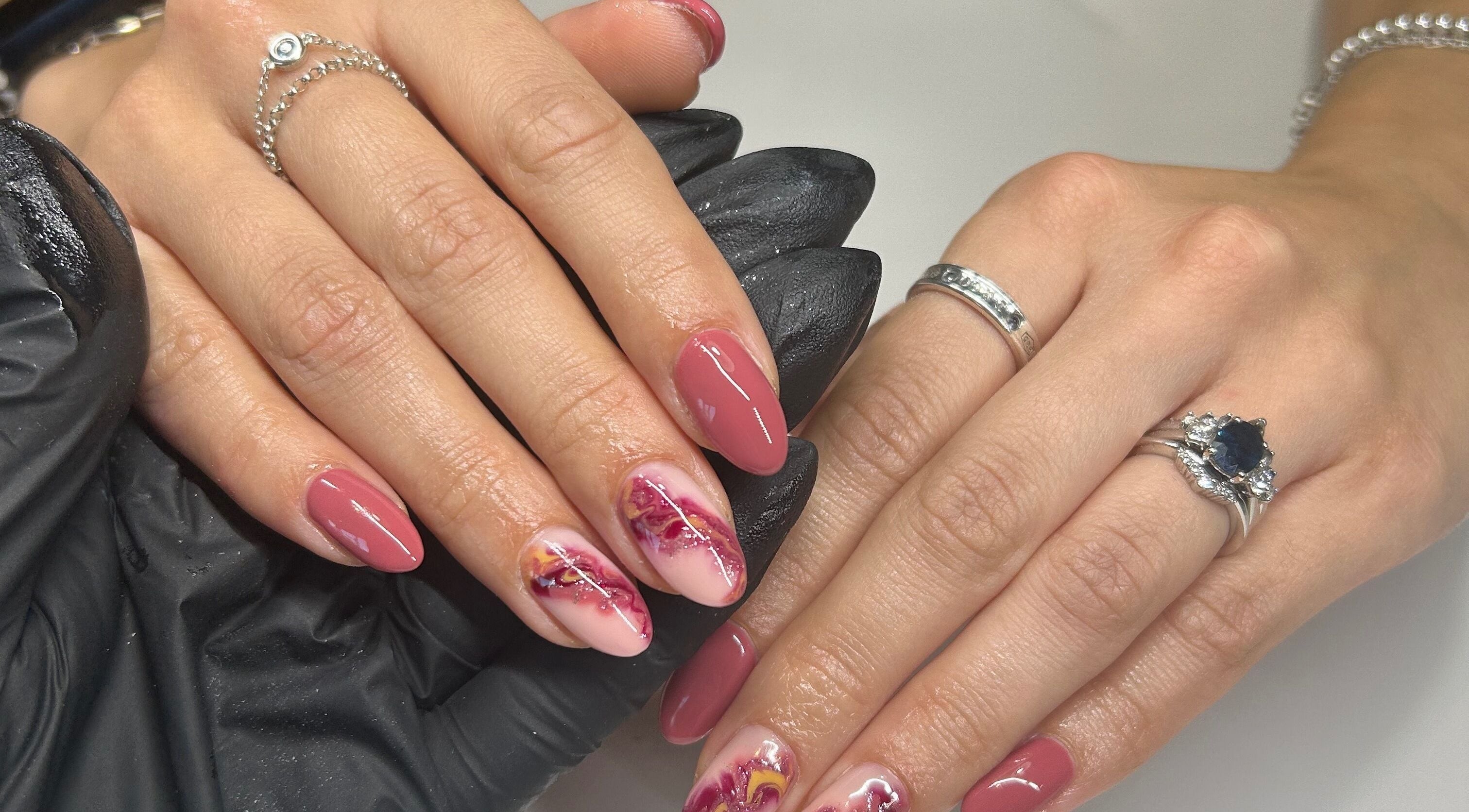 Stunning nail art at Sue Does Nails, Long Eaton, NG10 3RJ, England, GB, featuring intricate pink designs.