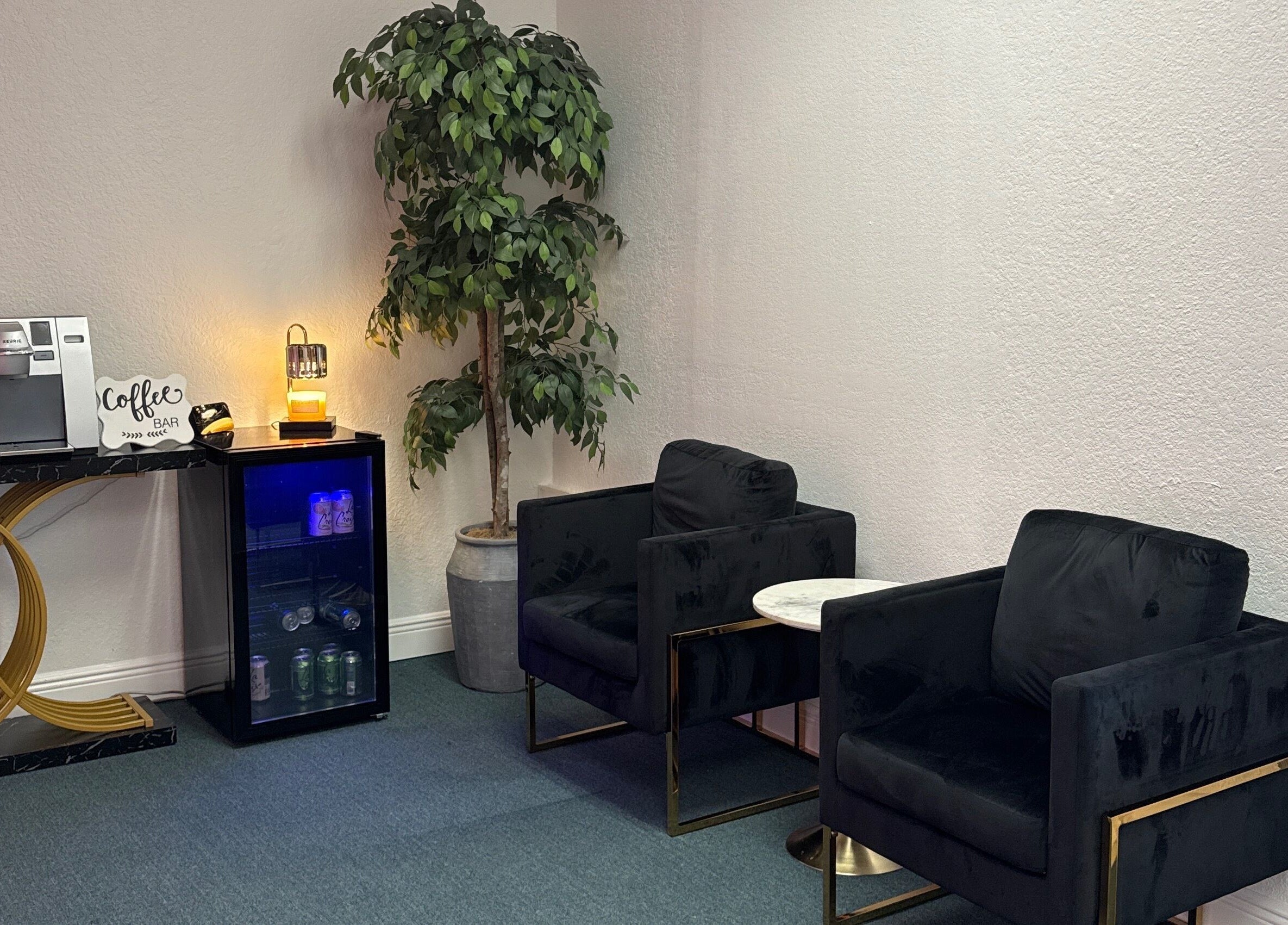 Relaxing lounge area with coffee station at iSugaring in Seminole, Florida, US offering comfort and style.