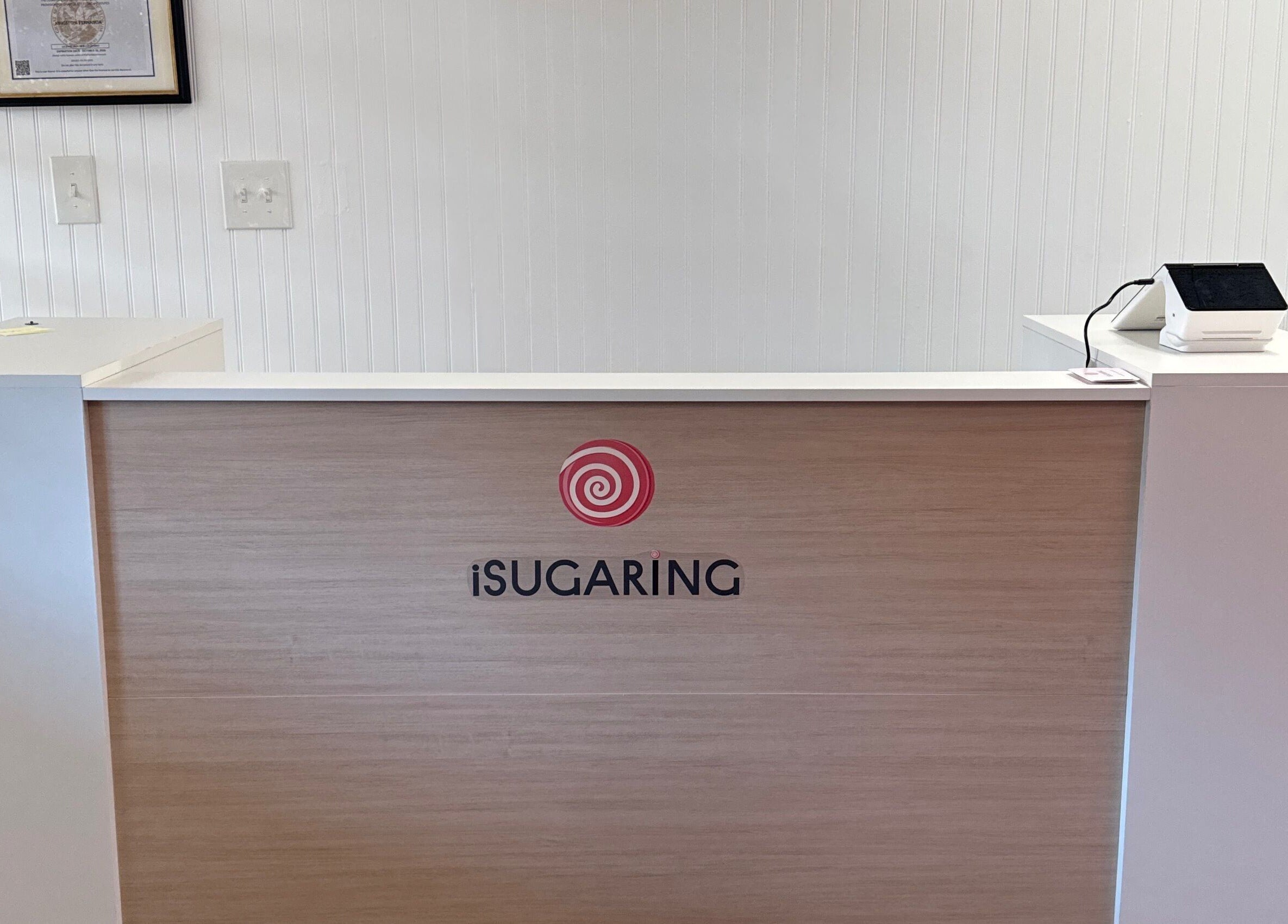 Reception desk at iSugaring in Seminole, Florida, US with sleek, modern design.