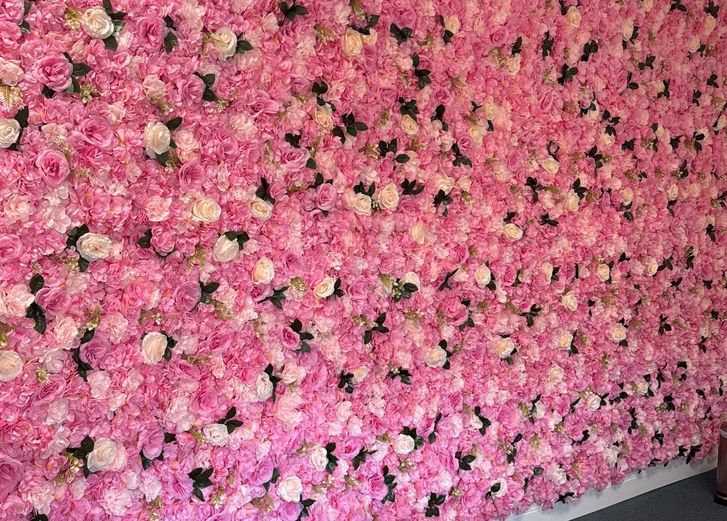 Elegant pink floral wall at iSugaring, Seminole, Florida, US, enhancing the venue's serene ambiance.