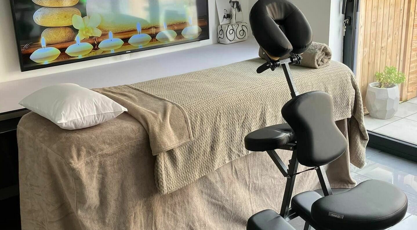 Relaxing massage setup at Pure Heaven Beauty, Cleveland, Queensland, AU with candles and serene decor.
