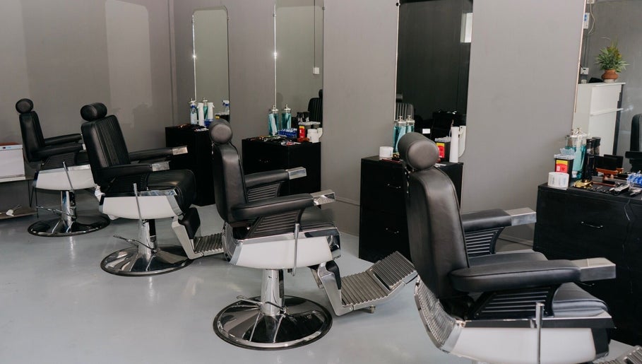 Modern barber chairs at Culture Barbershop, Mandalay, MM, with sleek design and equipment.