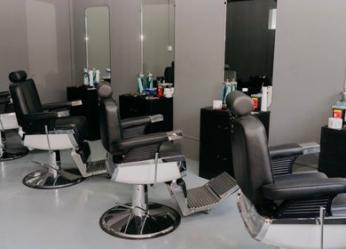 Modern barber chairs at Culture Barbershop, Mandalay, MM, with sleek design and equipment.