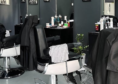 Modern barber chairs at Culture Barbershop in Mandalay, MM showcasing a stylish interior.