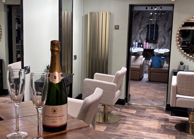Elegant interior of Another Salon in Swansea, GB with champagne and styling chairs.