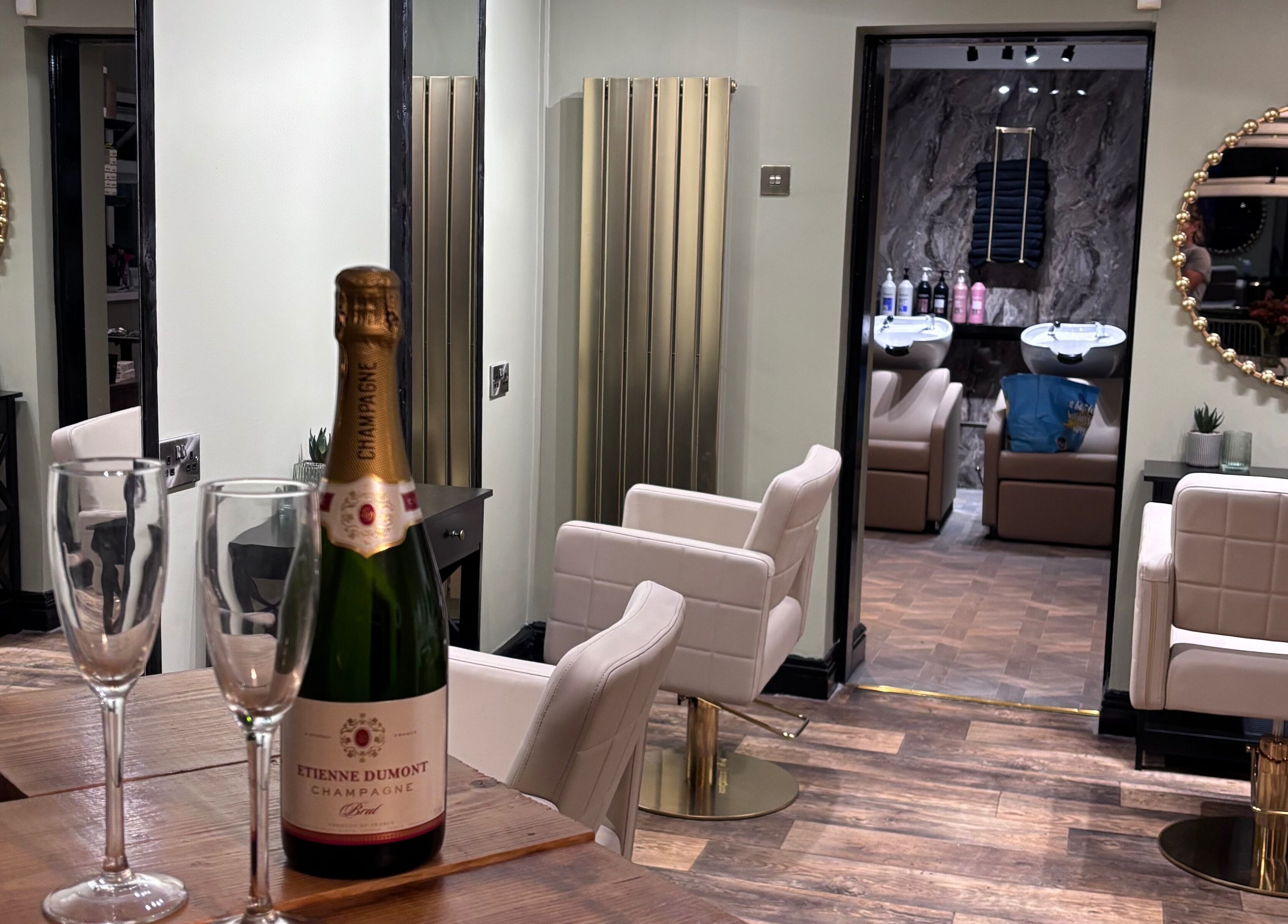 Elegant interior of Another Salon in Swansea, GB with champagne and styling chairs.