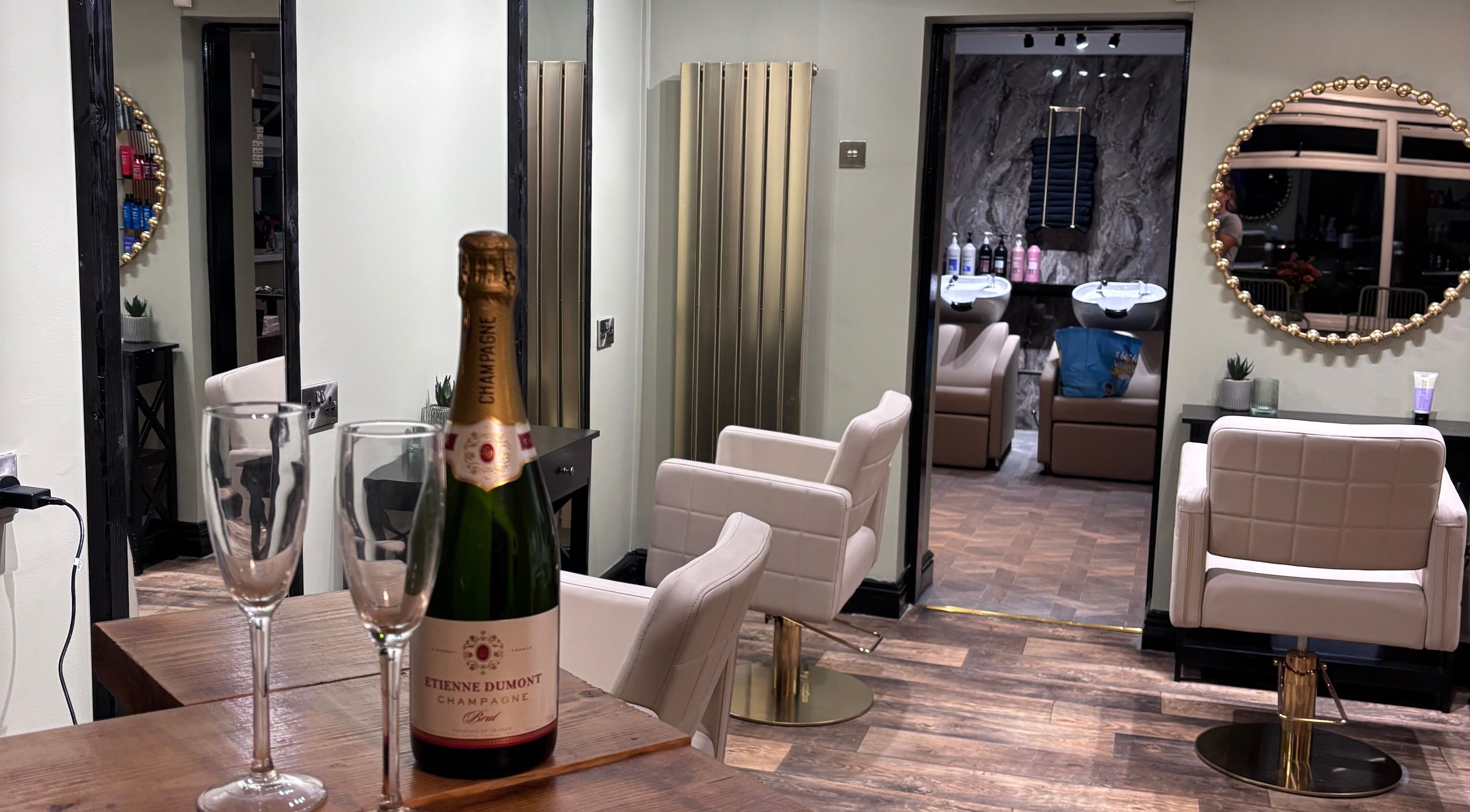 Elegant interior of Another Salon in Swansea, GB with champagne and styling chairs.