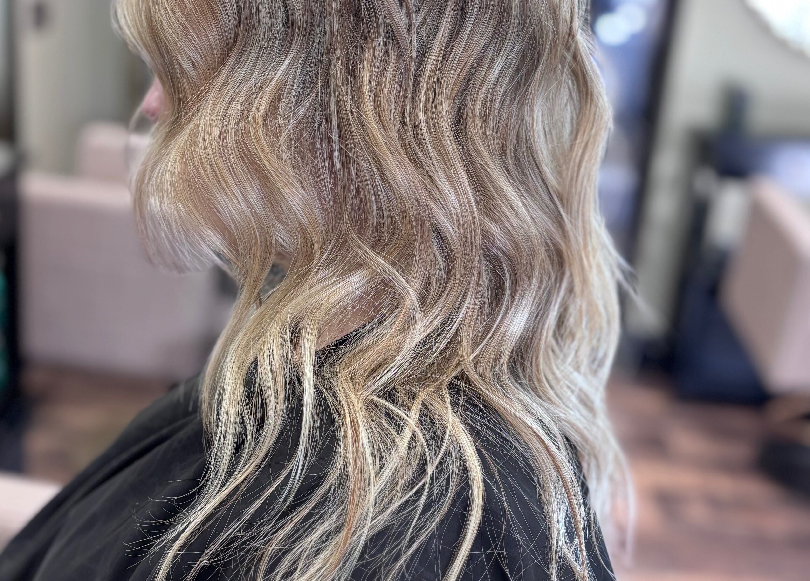 Wavy blonde hairstyle at Another Salon in Swansea, GB, showcasing expert styling techniques.
