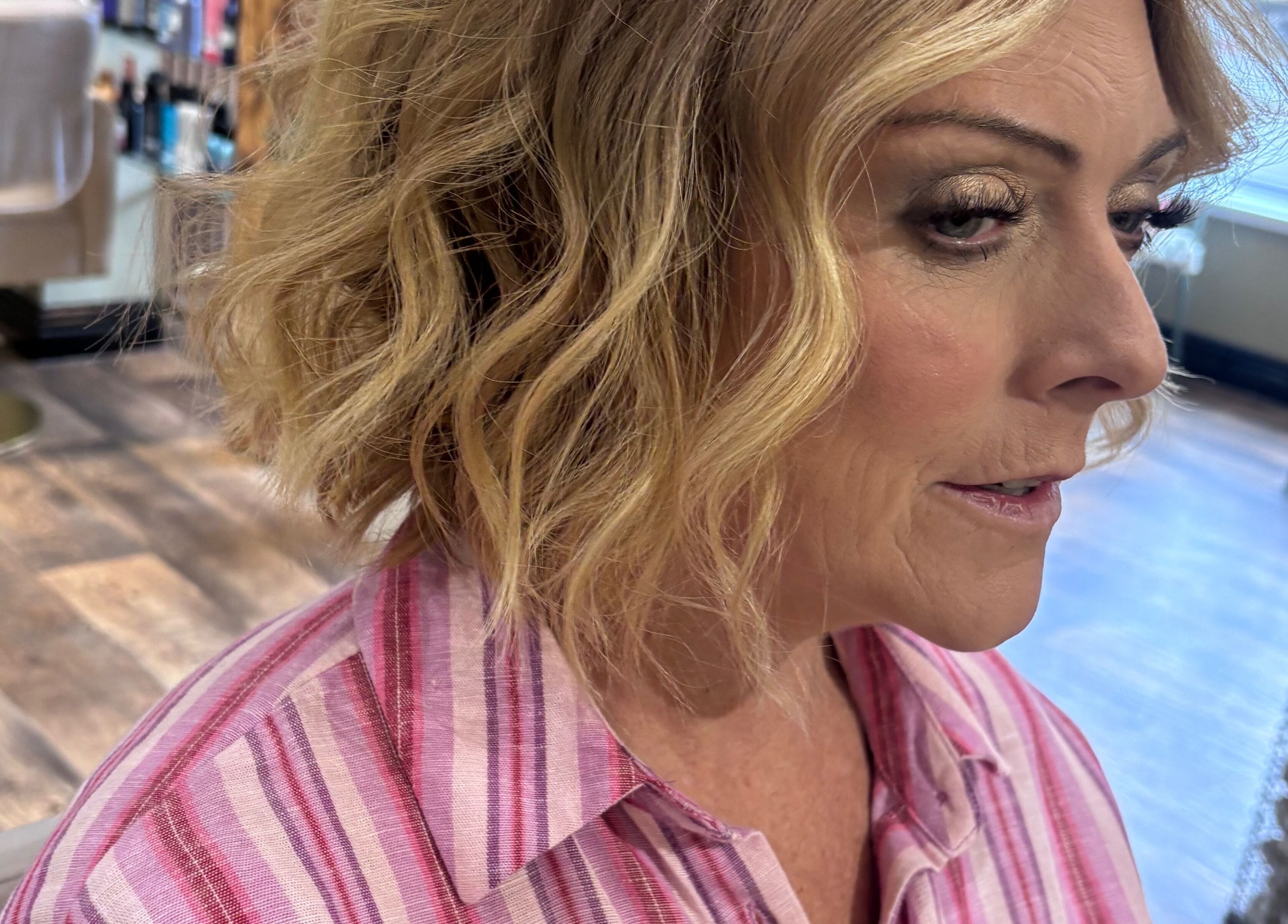 Client with styled blonde hair at Another Salon, Swansea, GB. Experience luxury hair care services.