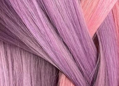 Vibrant purple and pink hair strands at EMWHAIR, Newport Pagnell, England, GB, showcasing modern dyeing techniques.