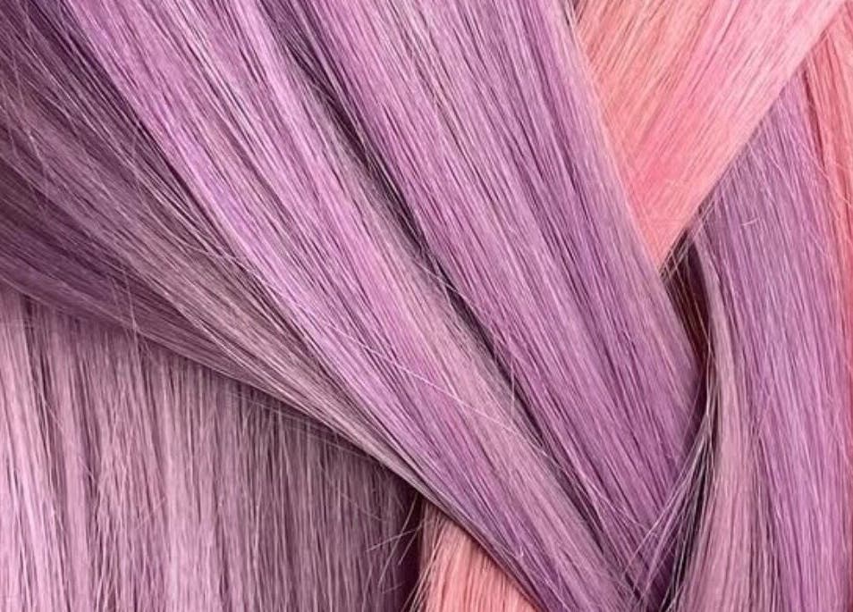 Vibrant purple and pink hair strands at EMWHAIR, Newport Pagnell, England, GB, showcasing modern dyeing techniques.