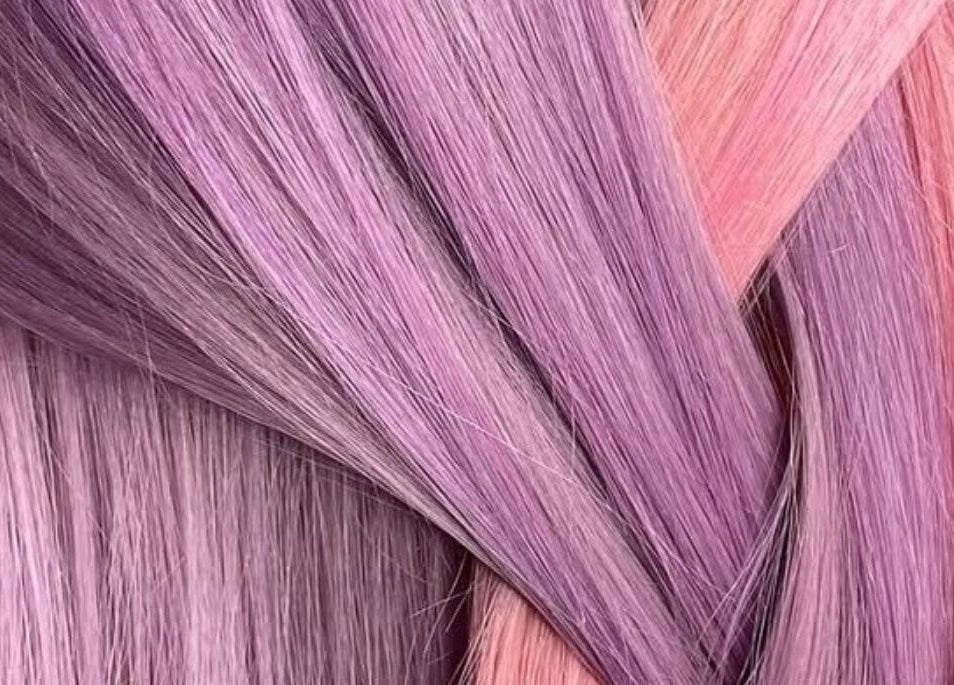 Vibrant purple and pink hair strands at EMWHAIR, Newport Pagnell, England, GB, showcasing modern dyeing techniques.
