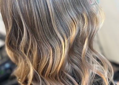 Stylish wavy hair highlighting expert styling at EMWHAIR, Newport Pagnell, England, GB.
