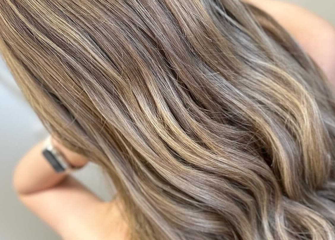 Elegant, wavy blonde hair at EMWHAIR salon, Newport Pagnell, England, GB.