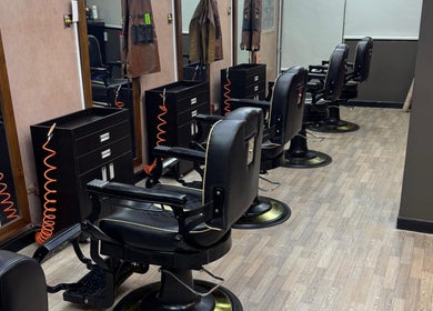 Interior moderno de D’Perú Barbershop en La Molina, Provincia De Lima, PE, mostrando sillas elegantes y espejos.