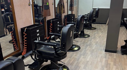 Interior moderno de D’Perú Barbershop en La Molina, Provincia De Lima, PE, mostrando sillas elegantes y espejos.