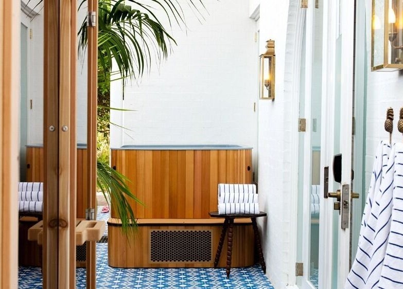 Relaxing spa nook at Halcyon Wellness, Cabarita Beach, New South Wales with wooden accents and striped towels.