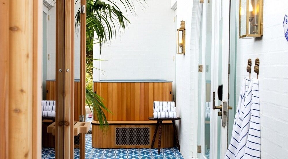 Relaxing spa nook at Halcyon Wellness, Cabarita Beach, New South Wales with wooden accents and striped towels.