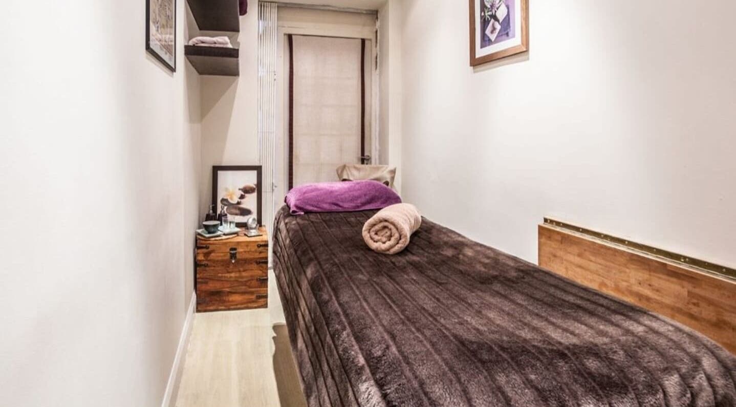 Comfortable massage room at Sacred Lotus, London, England, GB, with soft lighting and tranquil decor.