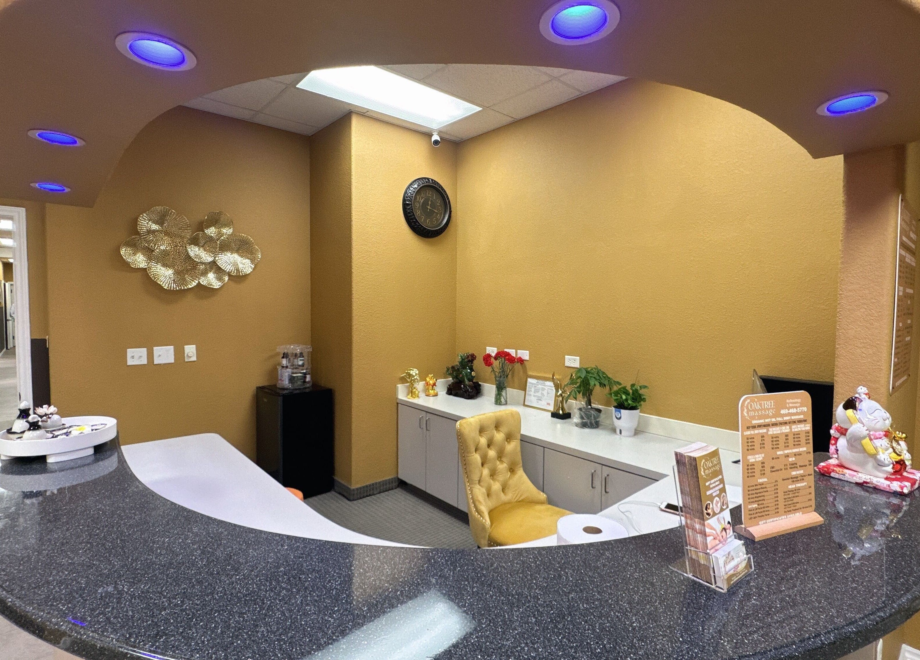 Reception area at Oak Tree Massage and Facial Frisco, Frisco, Texas, US with elegant decor and warm lighting.