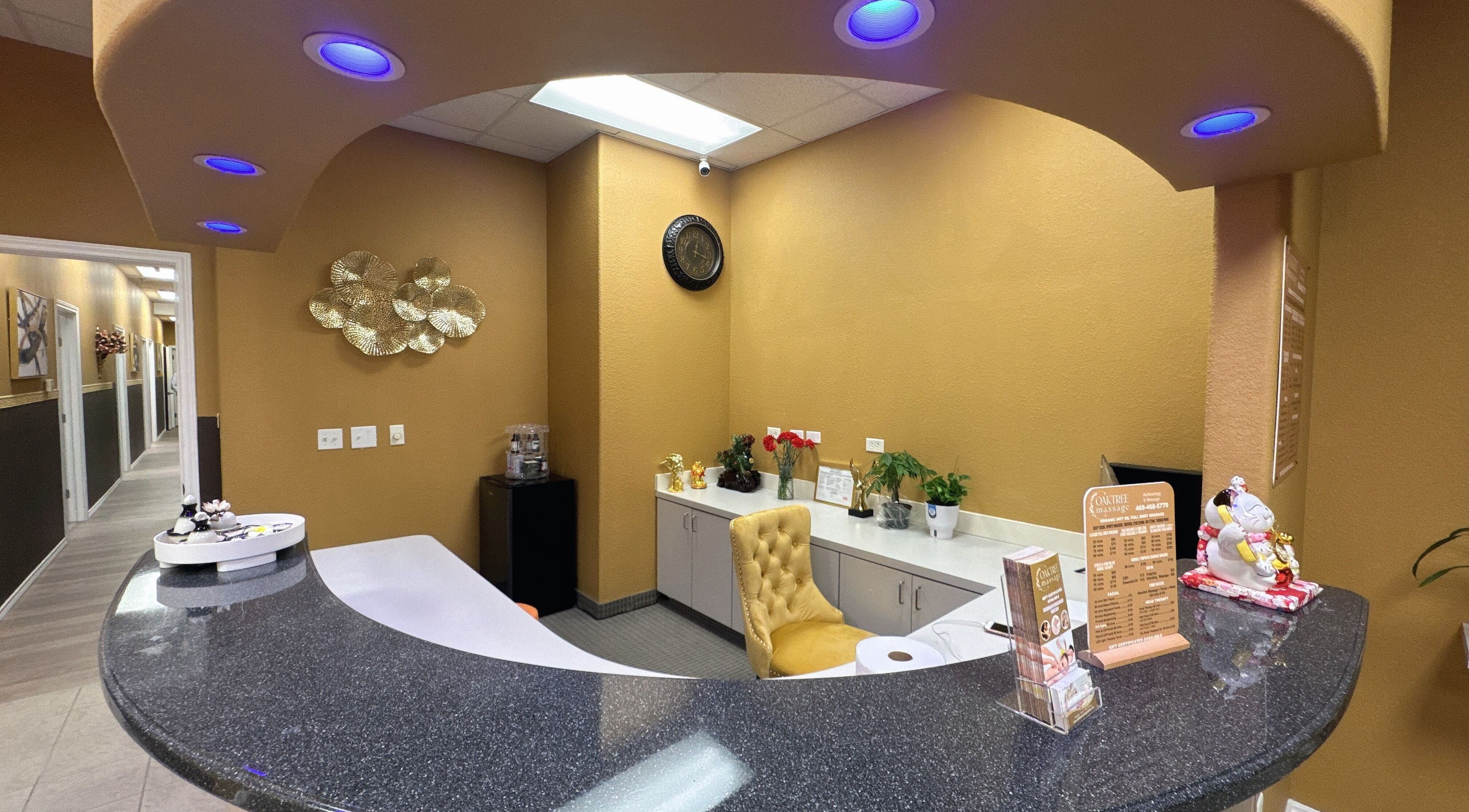 Reception area at Oak Tree Massage and Facial Frisco, Frisco, Texas, US with elegant decor and warm lighting.
