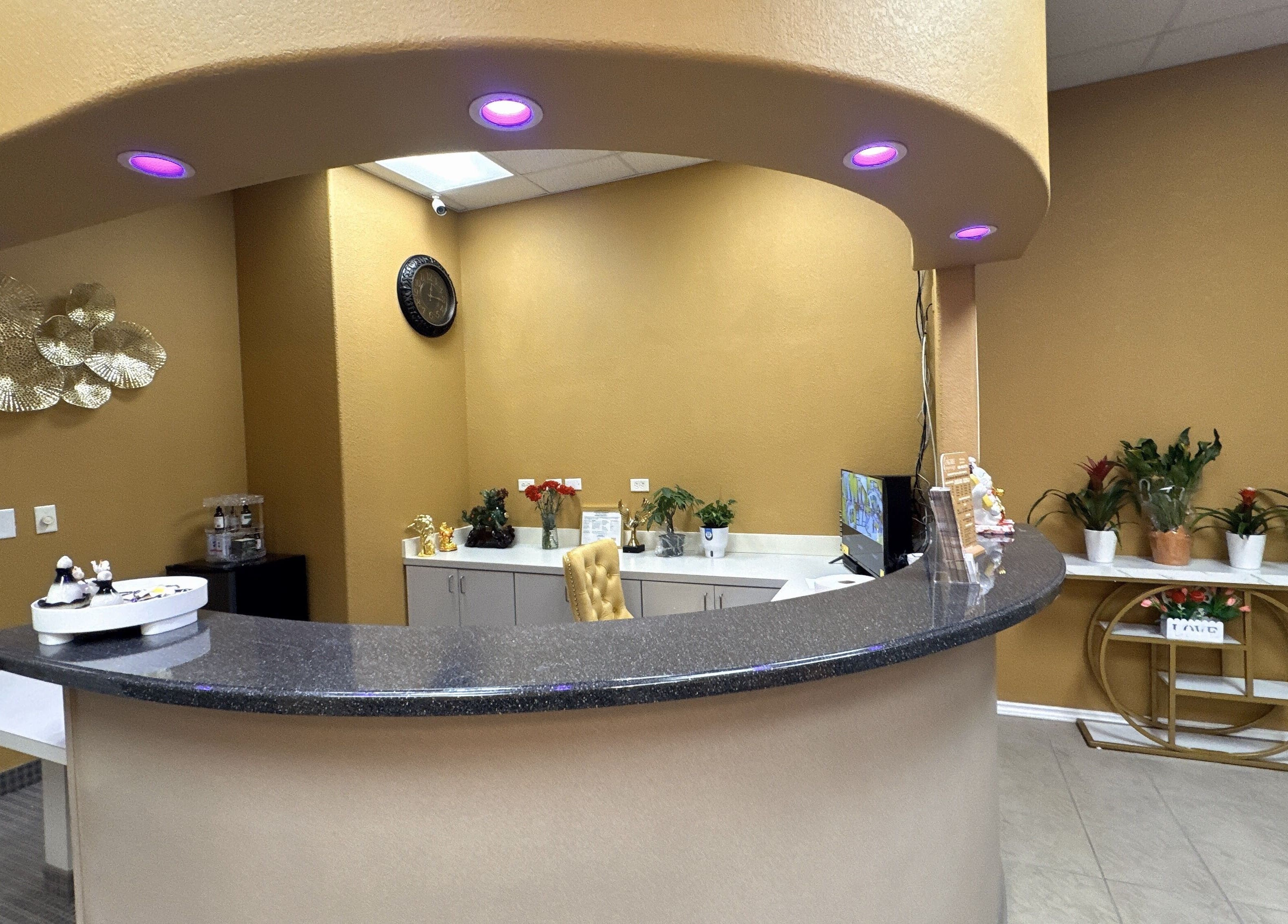 Reception area at Oak Tree Massage and Facial Frisco in Frisco, Texas, US with warm lighting and decor.