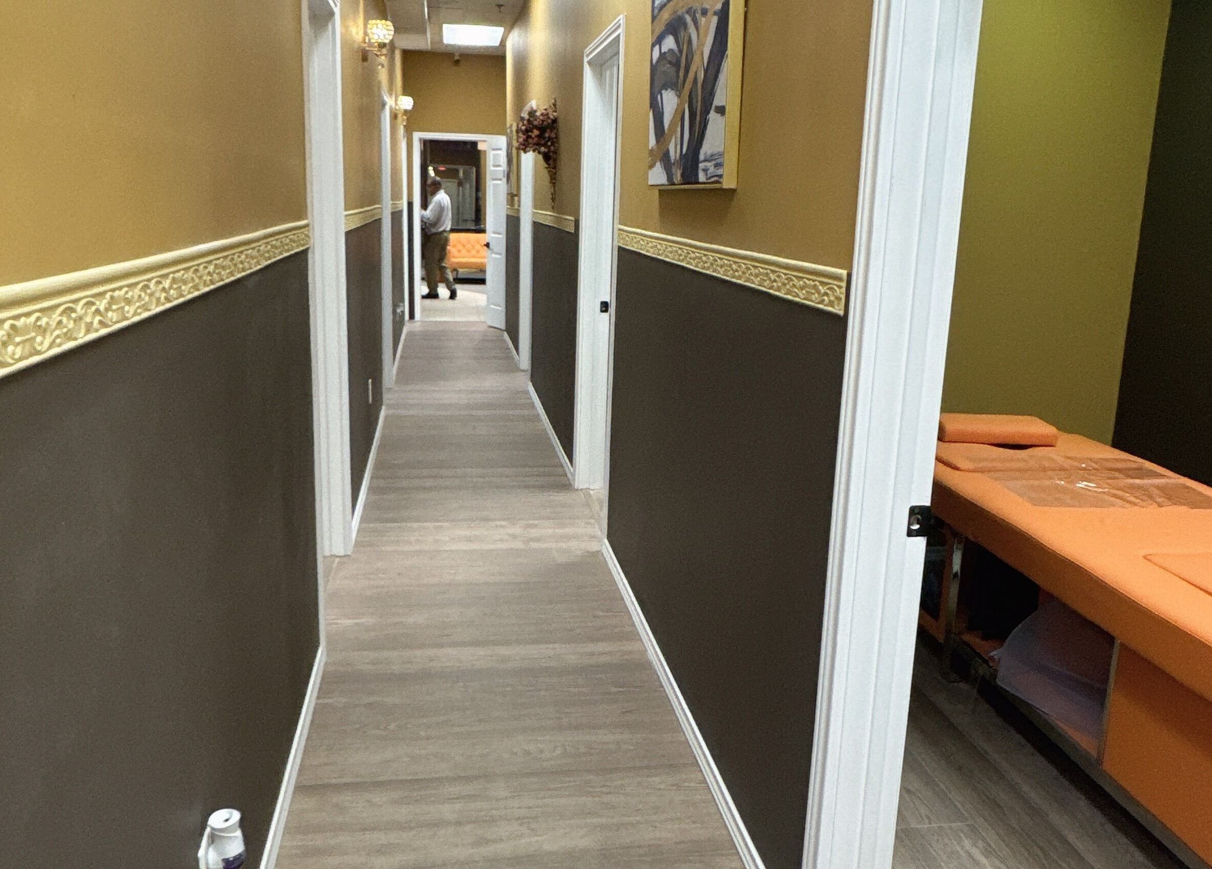 Tranquil hallway at Oak Tree Massage and Facial Frisco, Frisco, Texas, US, leading to cozy massage rooms.