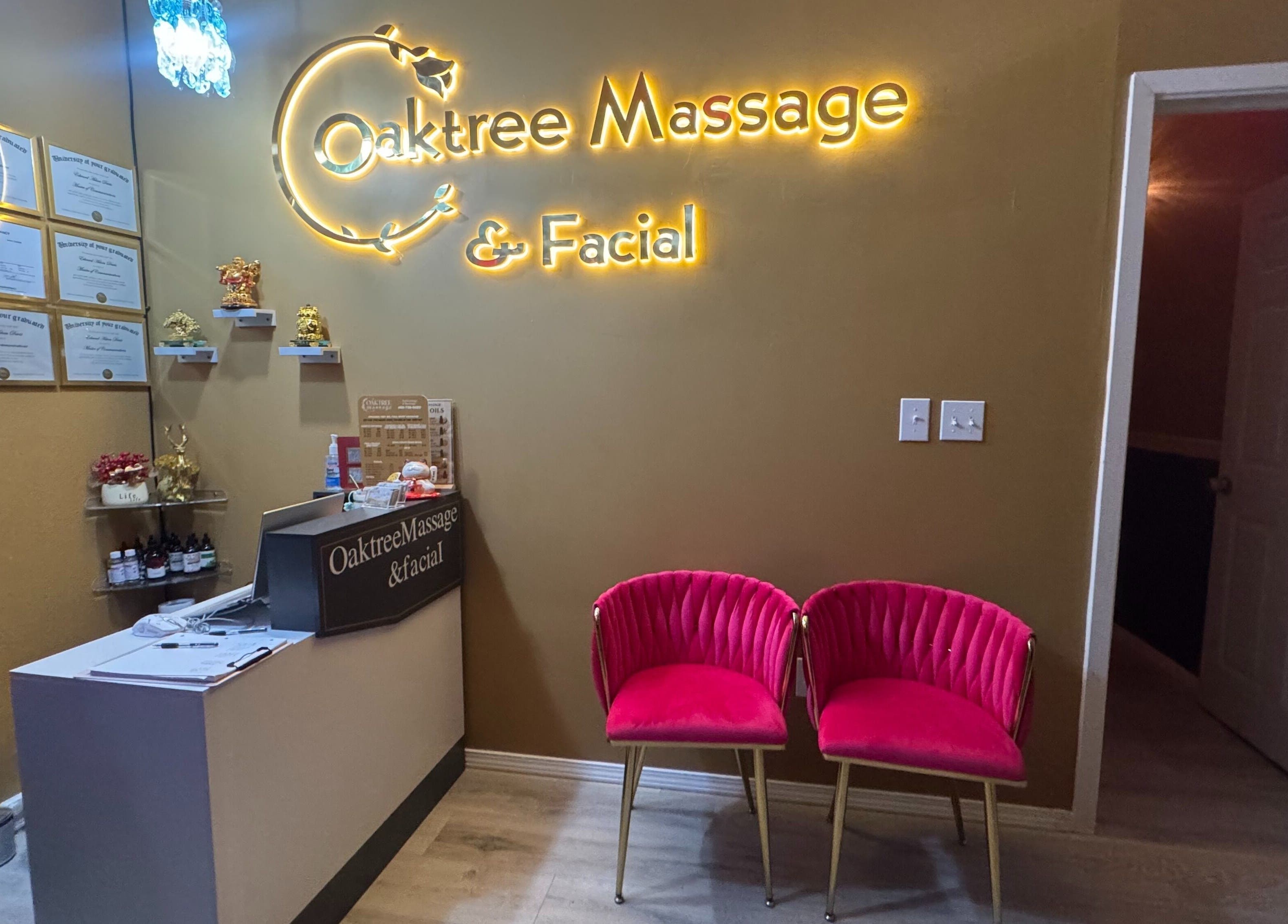 Reception area of Oak Tree Massage & Facial Lovers ln in Dallas, Texas, featuring plush seating and illuminated signage.
